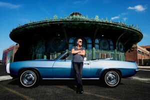 Bruce Springsteen stands in front of car in Asbury Park