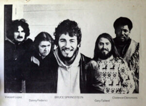 A publicity photo of Bruce Springsteen and the E Street Band around the time of "Greetings from Asbury Park, N.J." Left to right: Vini Lopez, Danny Federici, Springsteen, Gary Tallent and Clarence Clemons (whose name on the photo is misspelled). © Columbia Records