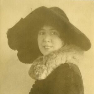 Antique sepia toned portrait of woman wearing large hat with large brim