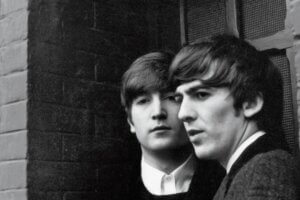 Vintage black and white image of John Lennon and George Harrison, of "The Beatles," in 1964