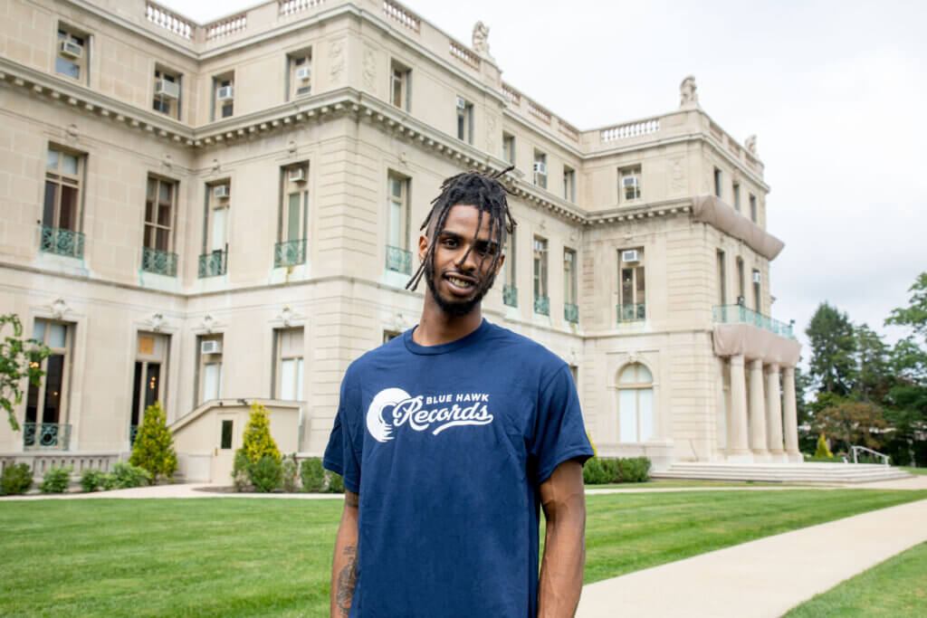 Asad Whitehead, a senior music industry student, in front of the Great Hall.