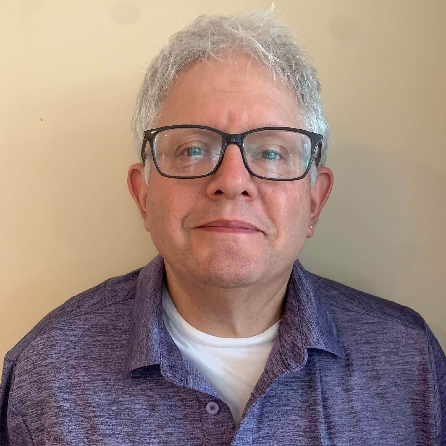 Head and should image of a man wearing glasses. Prof. Kenneth Campbell.