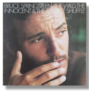 Cover of Bruce Springsteen's second album, "The Wild, The Innocent, and the E Street Shuffle" which features a picture of Springsteen looking pensively.