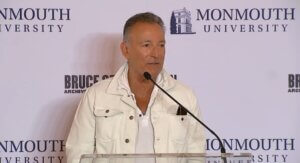 Bruce Springsteen speaking at podium into microphone