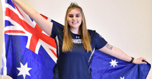 Woman in Monmouth University shirt holding flag of Australia