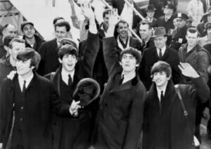 Black and white archival image of the musical group, The Beatles, in 1964