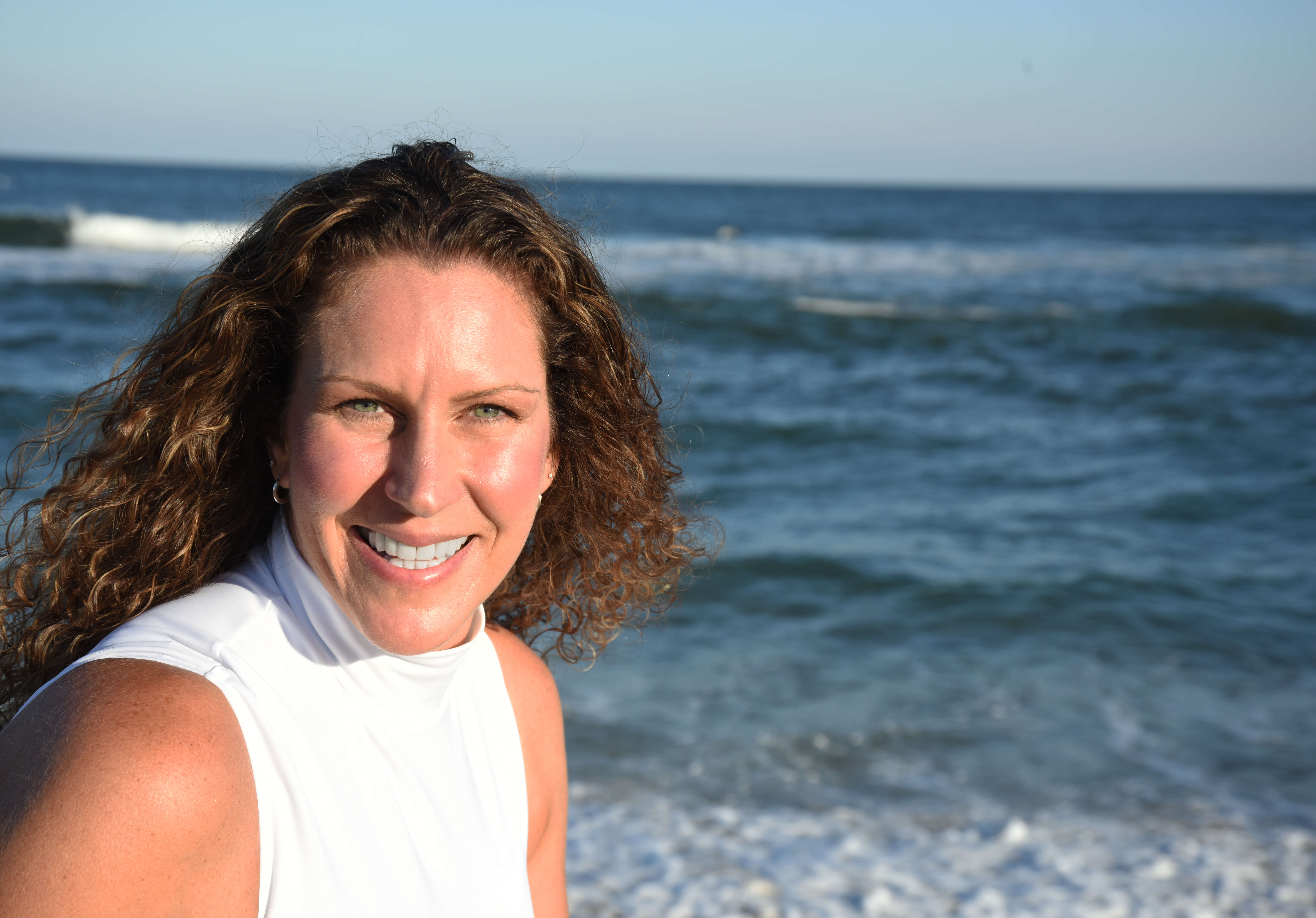 Headshot of Adjunct Professor Dawn Schultz in front of the ocean