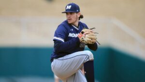Pitcher Trey Dombrowski in Monmouth baseball uniform, winding up for a pitch