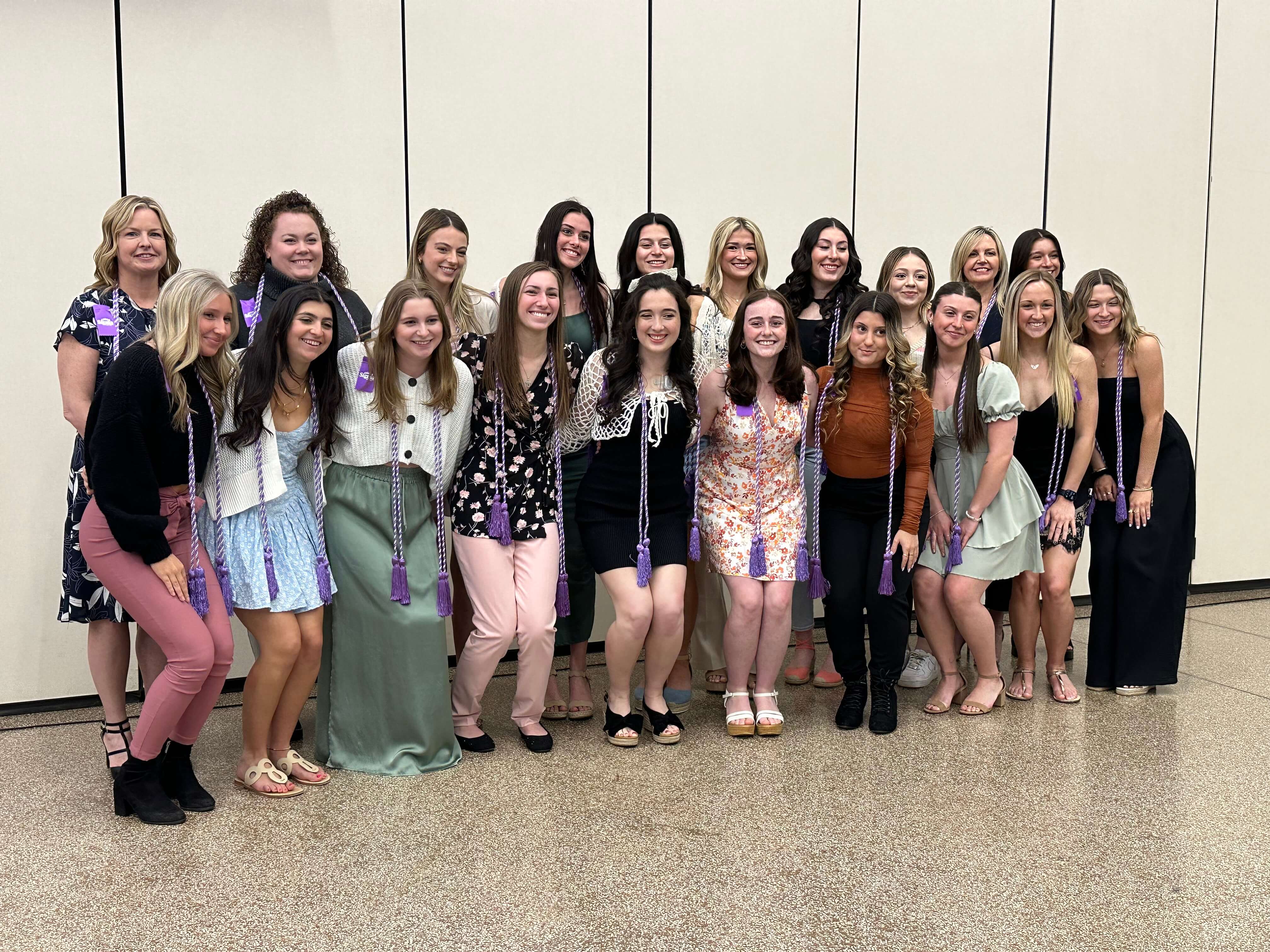 A group of female students with honor society cords.