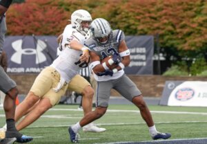 Monmouth's Deuce Lee scores on a 35-yard interception return against Lehigh.