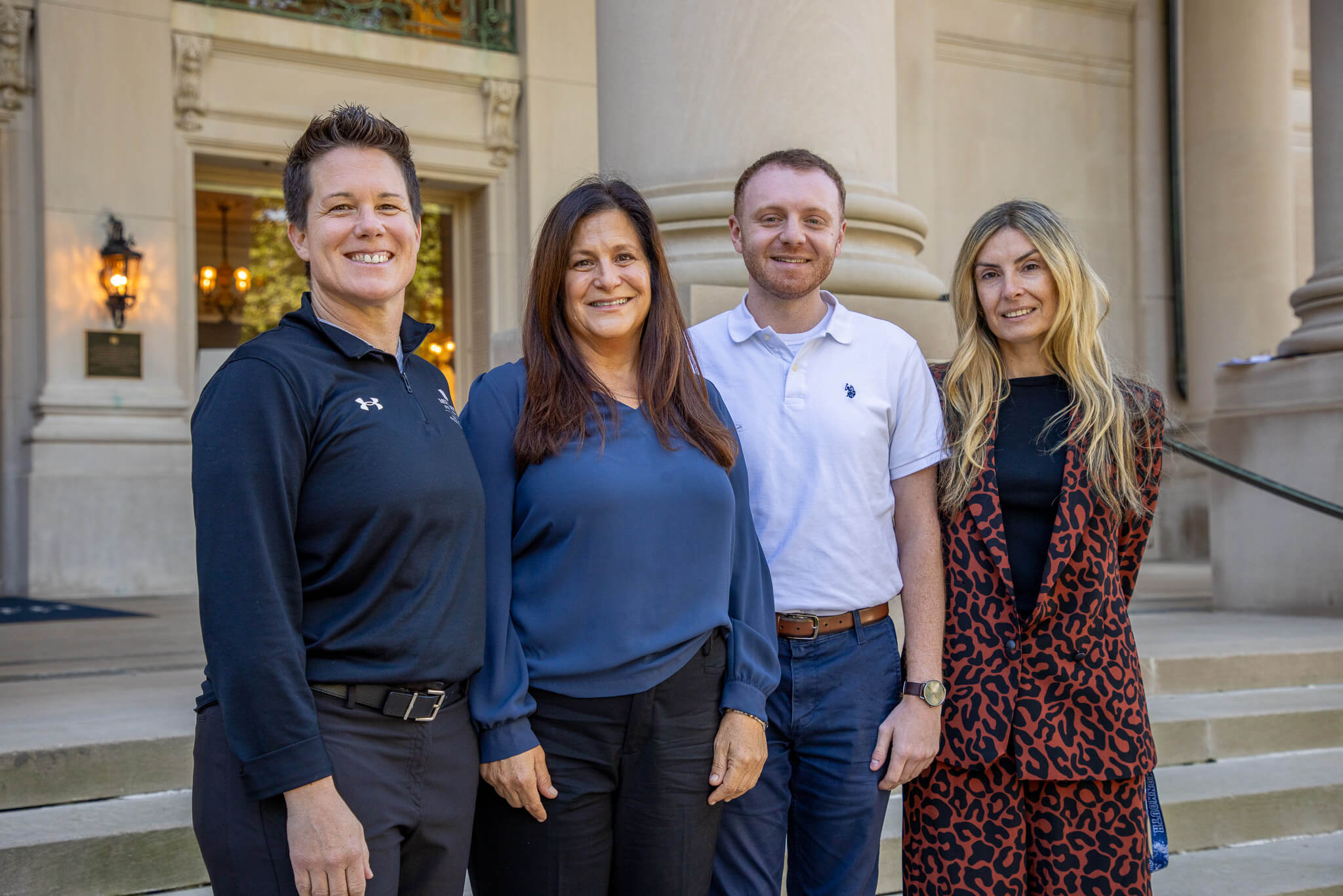 Professor Staci Drewson, Professor Andi Hope, graduate student Robert Milano, and Professor Tamara Rial Faigenbaum in front of the Great Hall