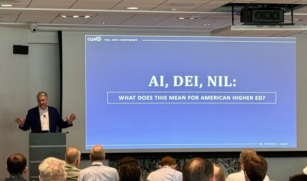 Monmouth University President Patrick F. Leahy stands before presentation screen