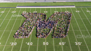 Arial view of Class of 2029 standing on Kessler Field in the shape of the Monmouth University "M"