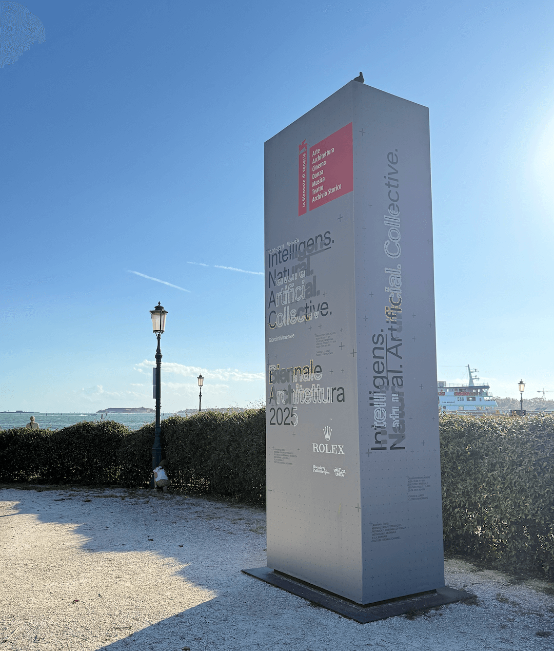 Gray entry column with exhibition texts at the start the Venice Architecture Biennial (2025).