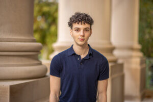 Headshot of junior Ikey Sasson in front of the Great Hall