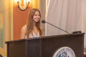 Senior Siena Zisa speaks from podium at UCI symposium