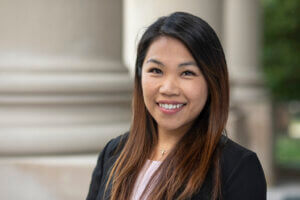 Headshot of Professor Cathy Wong in front of the Great Hall