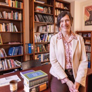 Prof. Kristin Bluemel in office surrounded by books