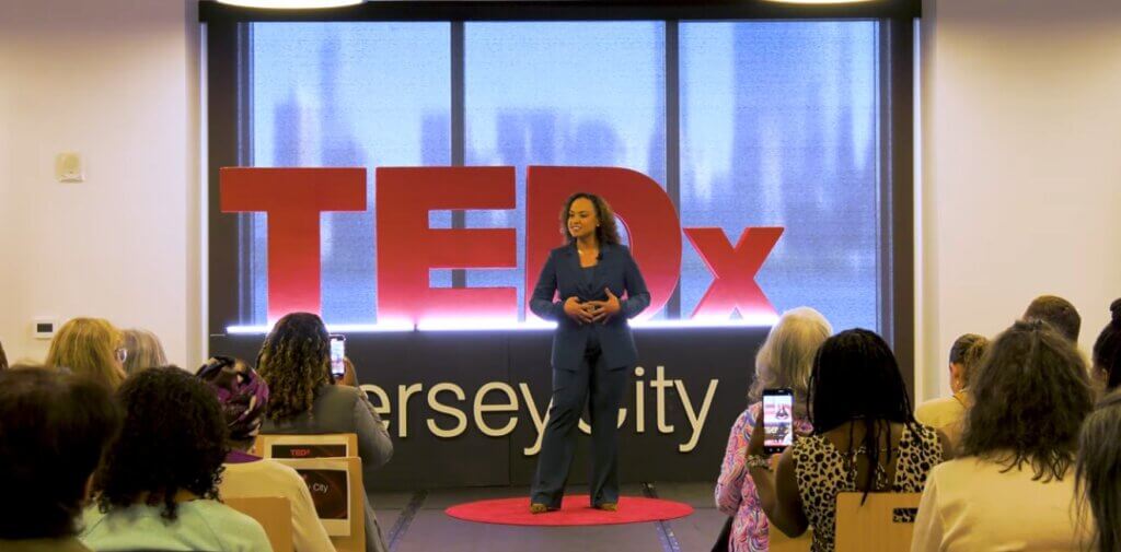 Prof. Nicole Pulliam speaks on stage at TEDx Jersey City event