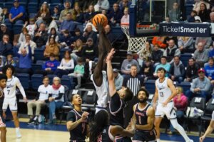 Monmouth basketball player Dok Muordar dunks during a game against Campbell