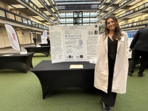 Sophia Ramirez Velandia standing with her research poster at the ICUNJ conference