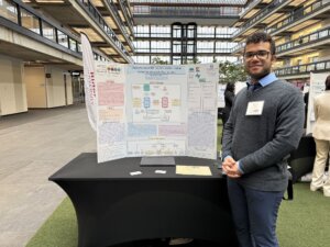 Zaccery Tarver standing with his research poster at the ICUNJ conference