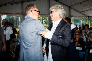 Bruce Springsteen greets Jon Bon Jovi at a ceremony for the Bruce Springsteen Center for American Music in Long Branch, N.J., on Saturday.Credit...Hannah Beier for The New York Times