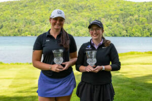 Monmouth's Dannah Smith and Jane Fanning posing on a golf course holding trophies