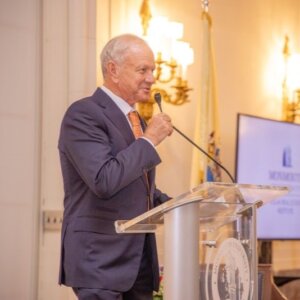 Man standing at clear podium