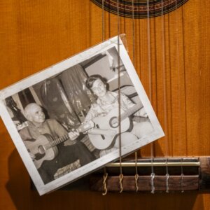 Black and white photo tucked into guitar strings as part of display at Springsteen Center