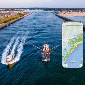 Composite image of cellphone showing mapping app, superimposed over ships in waterway as seen from aerial perspective