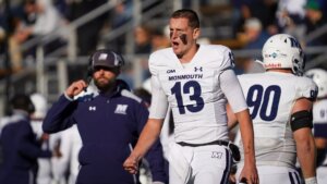 Football players in uniform on the sidelines