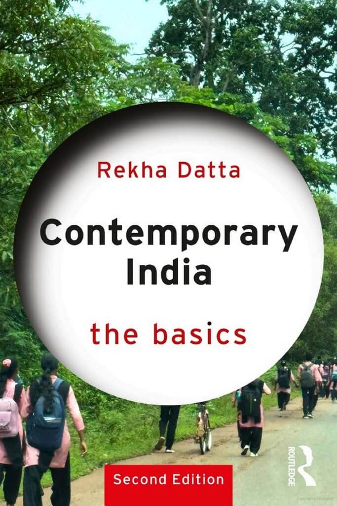 Cover of the second edition of the textbook, Contemporary India: the basics, written by Rekha Datta. The coverimage contains that text, and a background image of people walking on a road. The image also contains a hyperlink to the website of the book publisher.