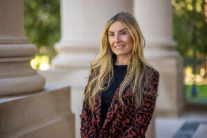 Specialist professor Tamara Rial-Faigenbaum standing at exterior of Great Hall