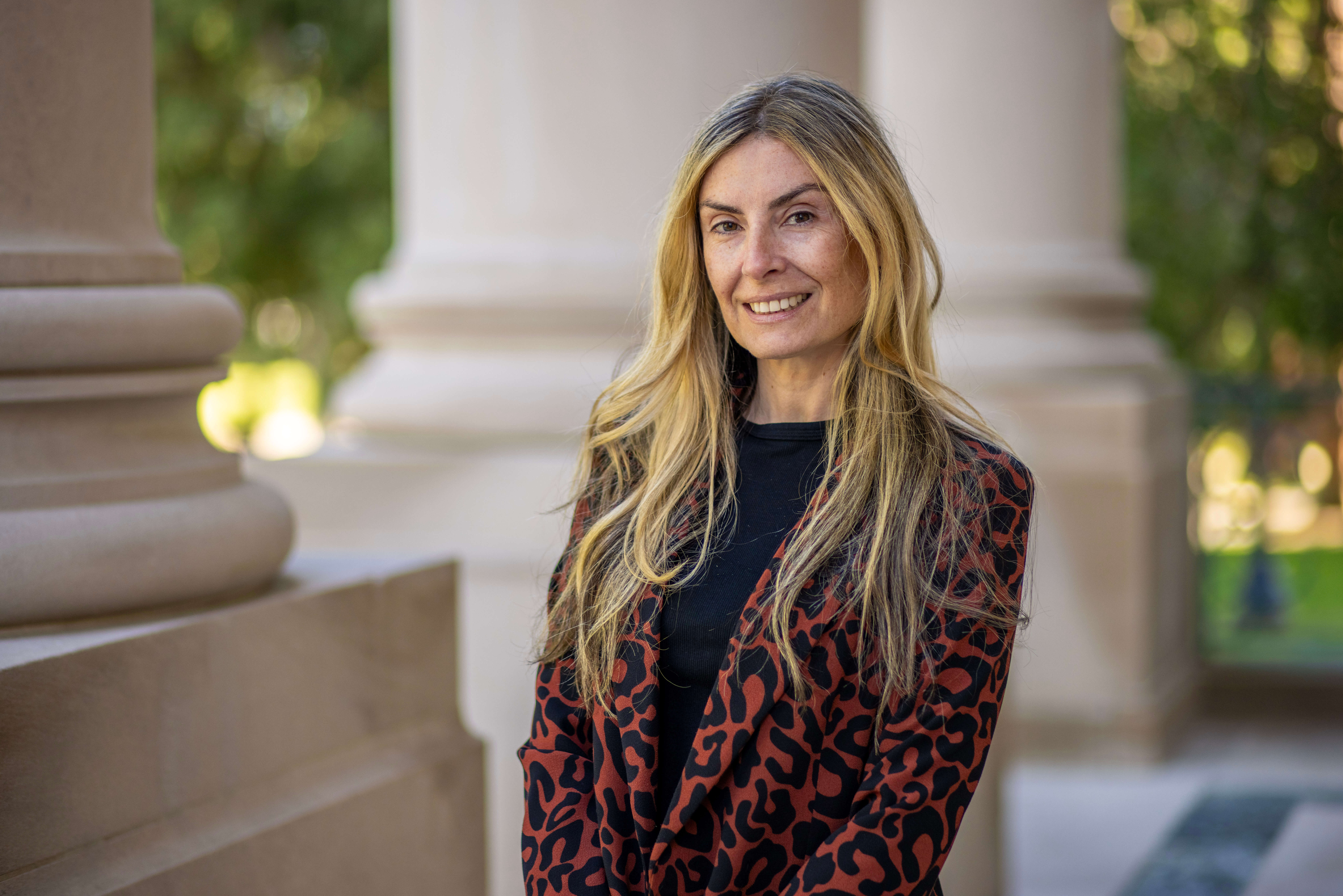 Specialist professor Tamara Rial-Faigenbaum standing at exterior of Great Hall