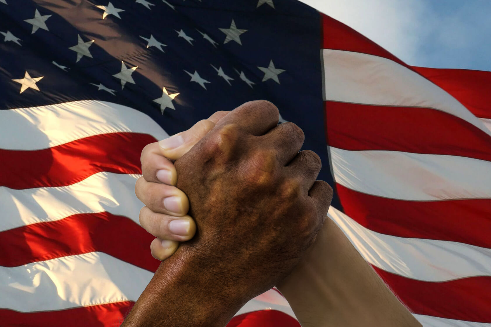 Image of hands in front of American flag.