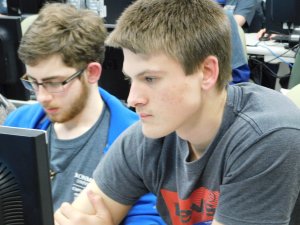 2 male students looking at their computer