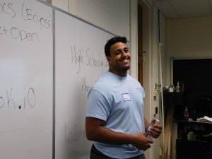 1 male Monmouth University student volunteer smiling at the camera