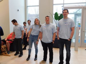 3 MU students in the foreground smiling for the camera