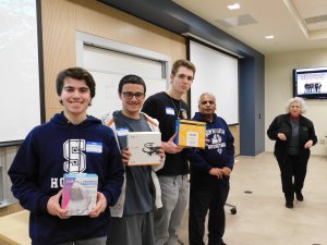 3 male students, sponsor Dr. Lakshmanan and MU Professor Kretsch. Students are holding prizes won for 3rd place in Monmouth University High School Programming contest 2019