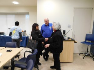 MU Professor Kretsch shaking hands with a female with Middletown High School South teacher Mr. Kretsch in the background