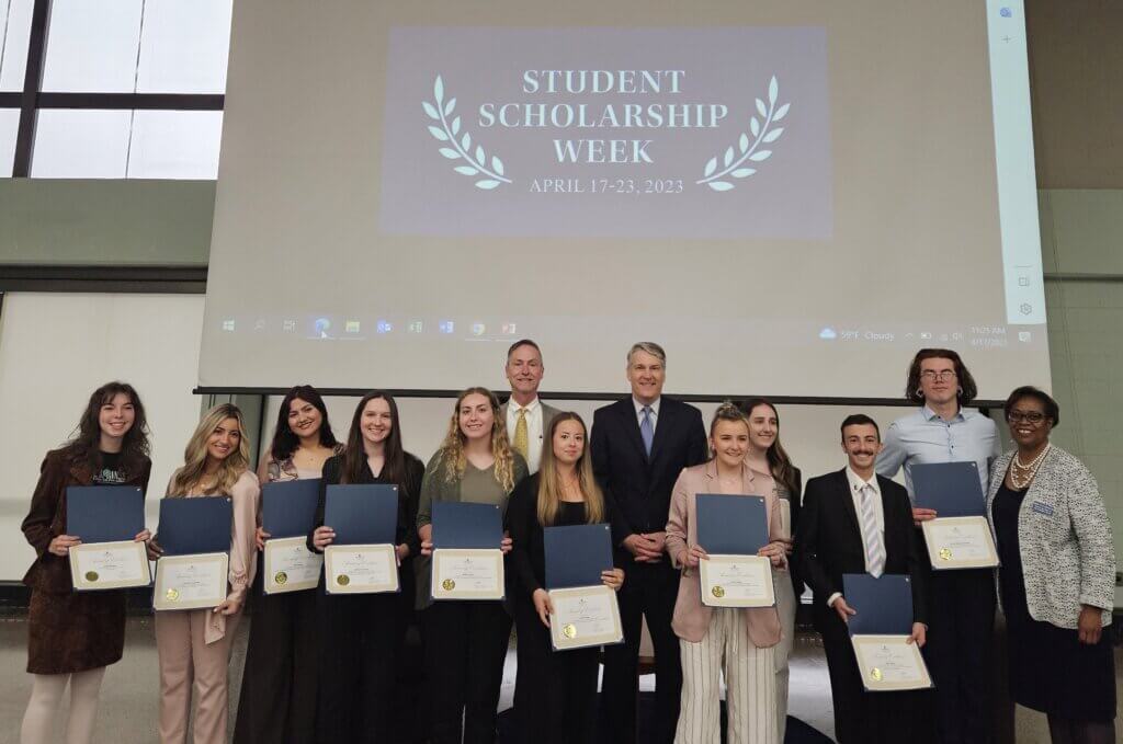 A group of people holding awards posing for group photo