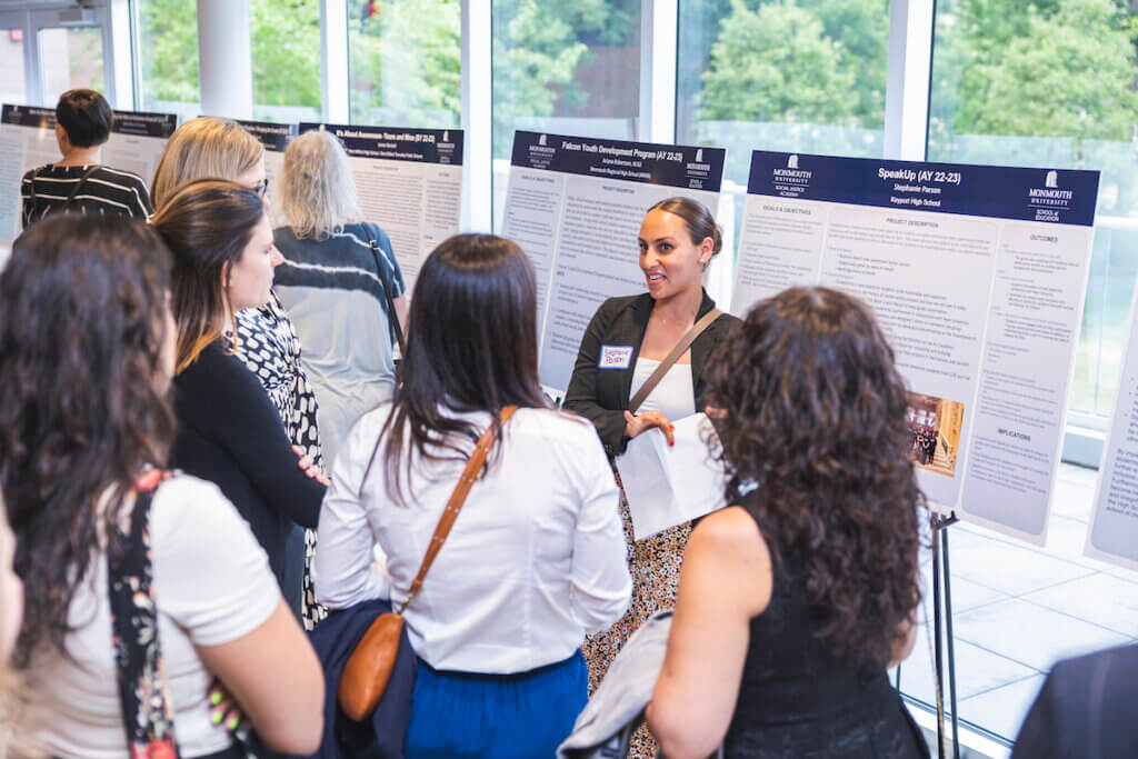 Professional presenting poster presentation to group