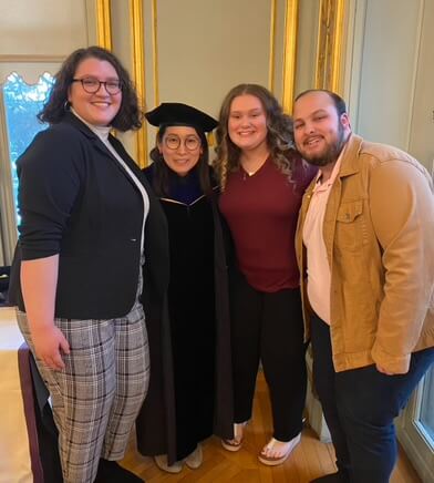 A group of students and a professor at the Kappa Delta Phi Induction 