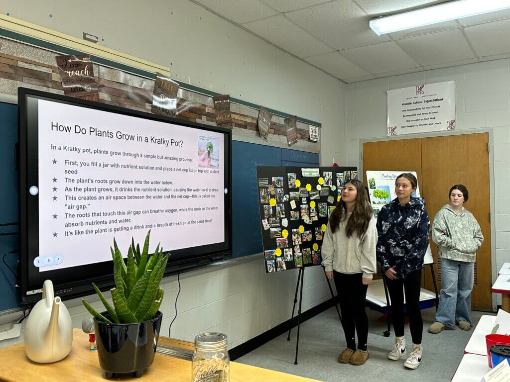 A students delivering a presentation on types of planters.