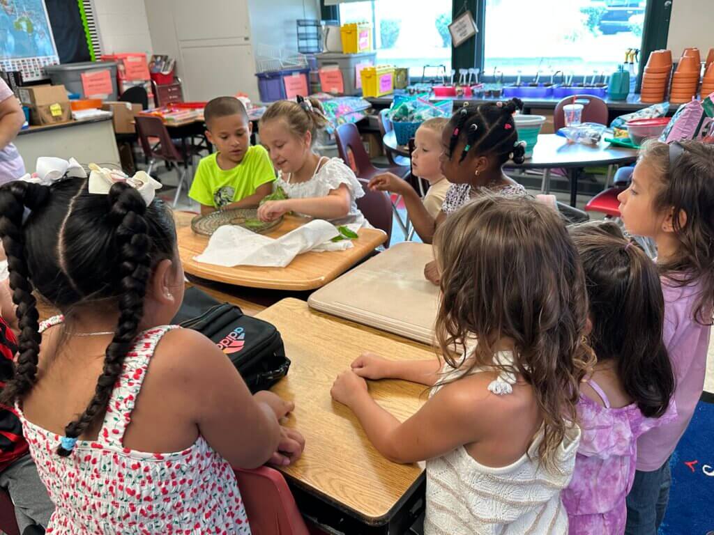 A table of students talking and working together.
