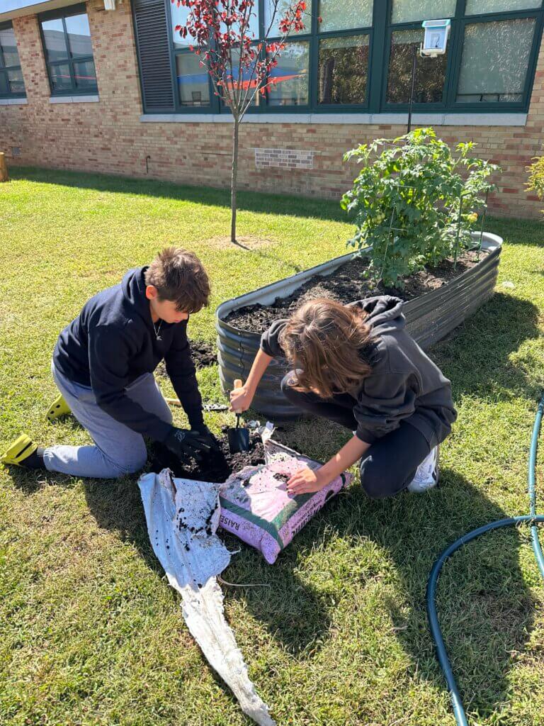 Students opening a bag of soil.