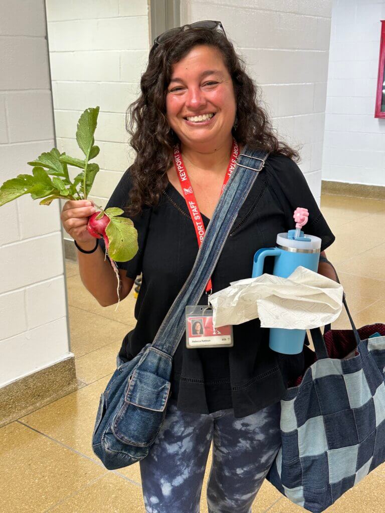 A teacher holding a radish.