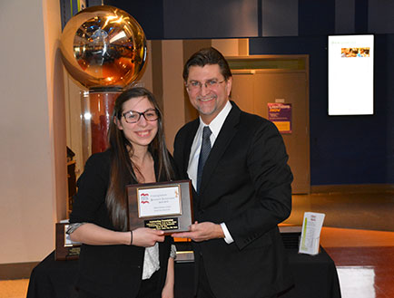 Photo of Nicole R Famularo receiving the Outstanding Presentation Award during the 2014-2015 Undergraduate Research Symposium of the Independent College Fund of New Jersey