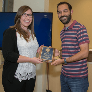Photo shows student Kristina Guarino receiving the Academic Achievement Award at 2017 Student Research Conference.